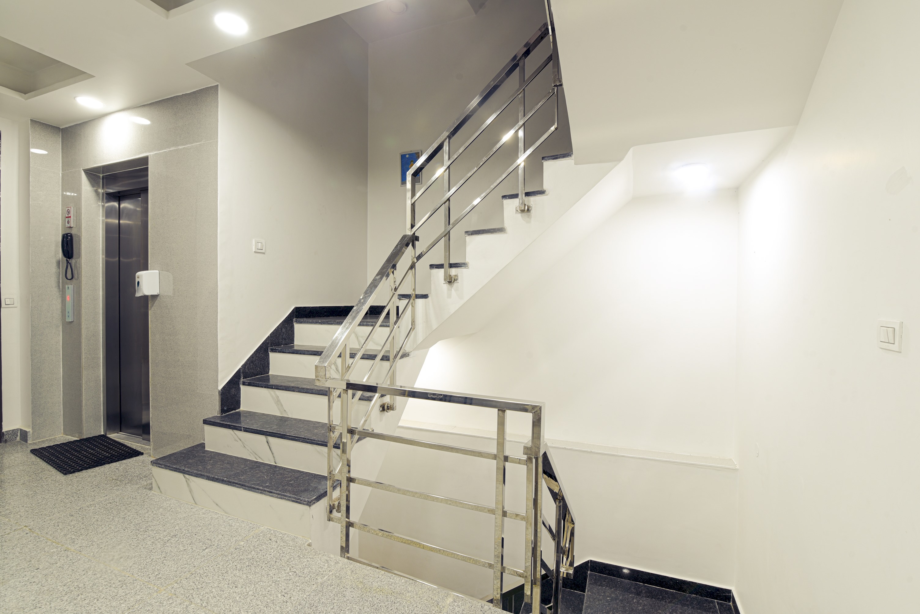 A split image featuring a modern elevator and a classic staircase, highlighting the options for vertical movement in a building
