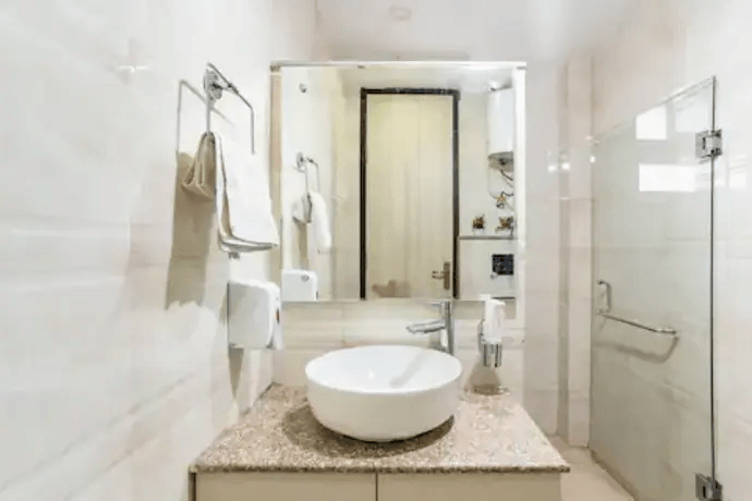 A luxurious bathroom with marble accents, a sleek soaking tub, a spacious glass-enclosed shower, and contemporary fixtures -pafaitstreet