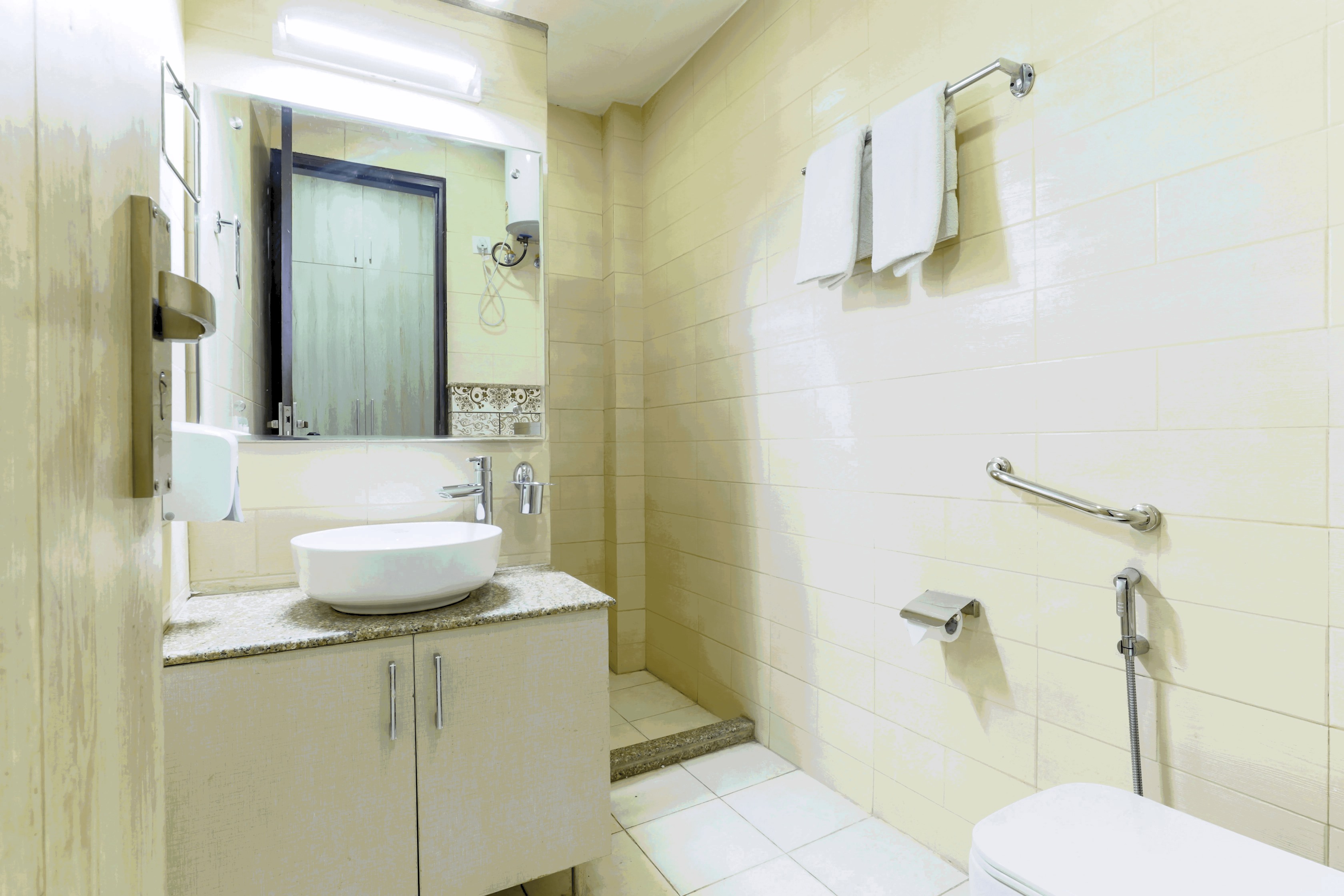 Parfait Street Convenience: Enjoy the comfort and privacy of a modern, attached bathroom with all the essential fixtures including a shower, sink, and toilet for your convenience
