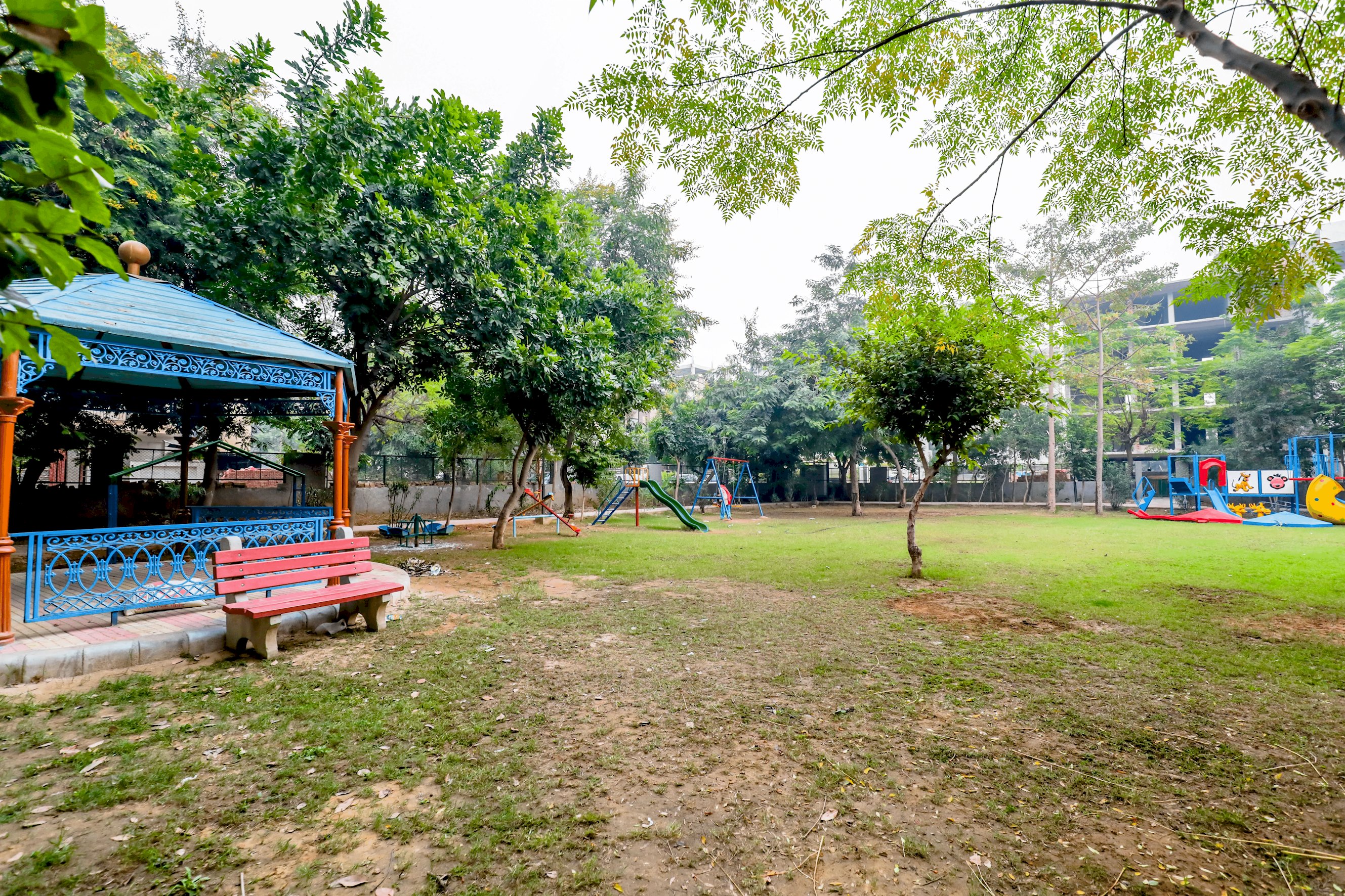 A picturesque view of the park, with lush greenery, walking paths, and a serene natural setting
