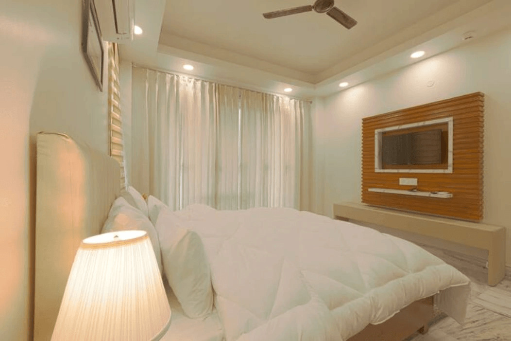 An elegant and well-designed bedroom with tasteful decor, comfortable furnishings, and a soothing color palette, creating a serene and inviting atmosphere