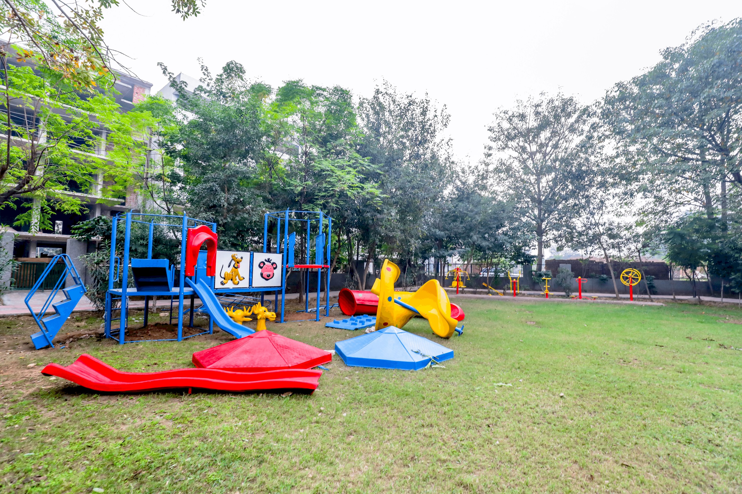 A vibrant park scene featuring children enjoying rides and games, with colorful play equipment and joyful laughter filling the air
