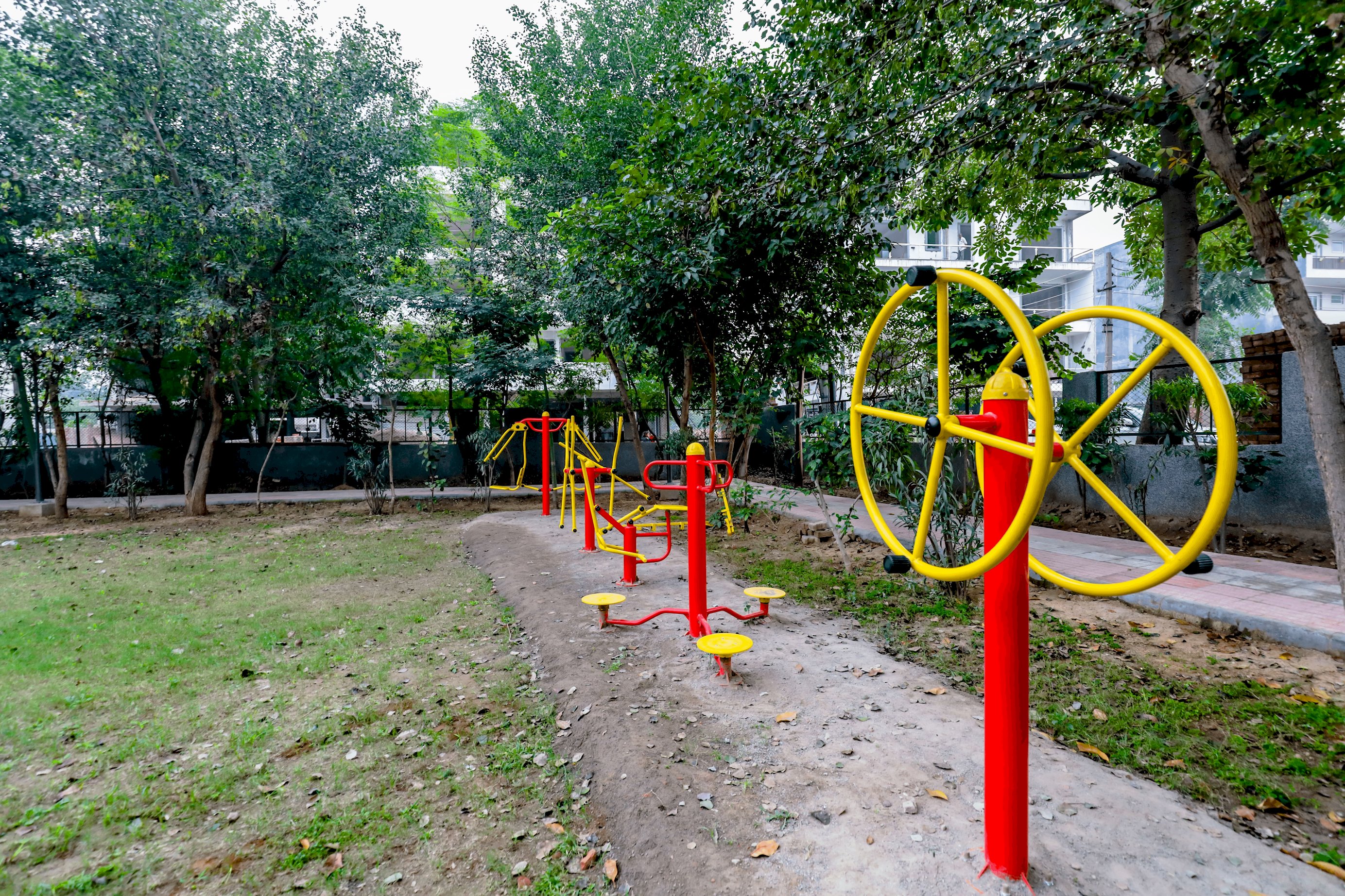 A Dynamic Park Scene with Children Delighting in Rides and Games, Surrounded by Playful Equipment, Echoing with Joyful Laughter.
