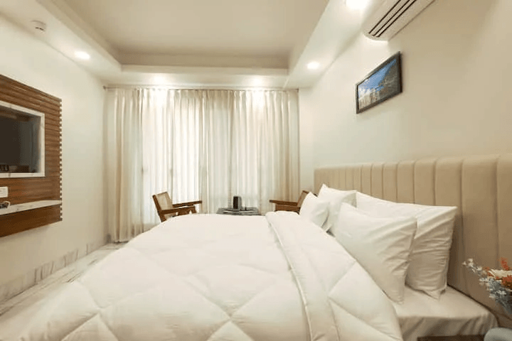 An elegant and well-designed bedroom with tasteful decor, comfortable furnishings, and a soothing color palette, creating a serene and inviting atmosphere