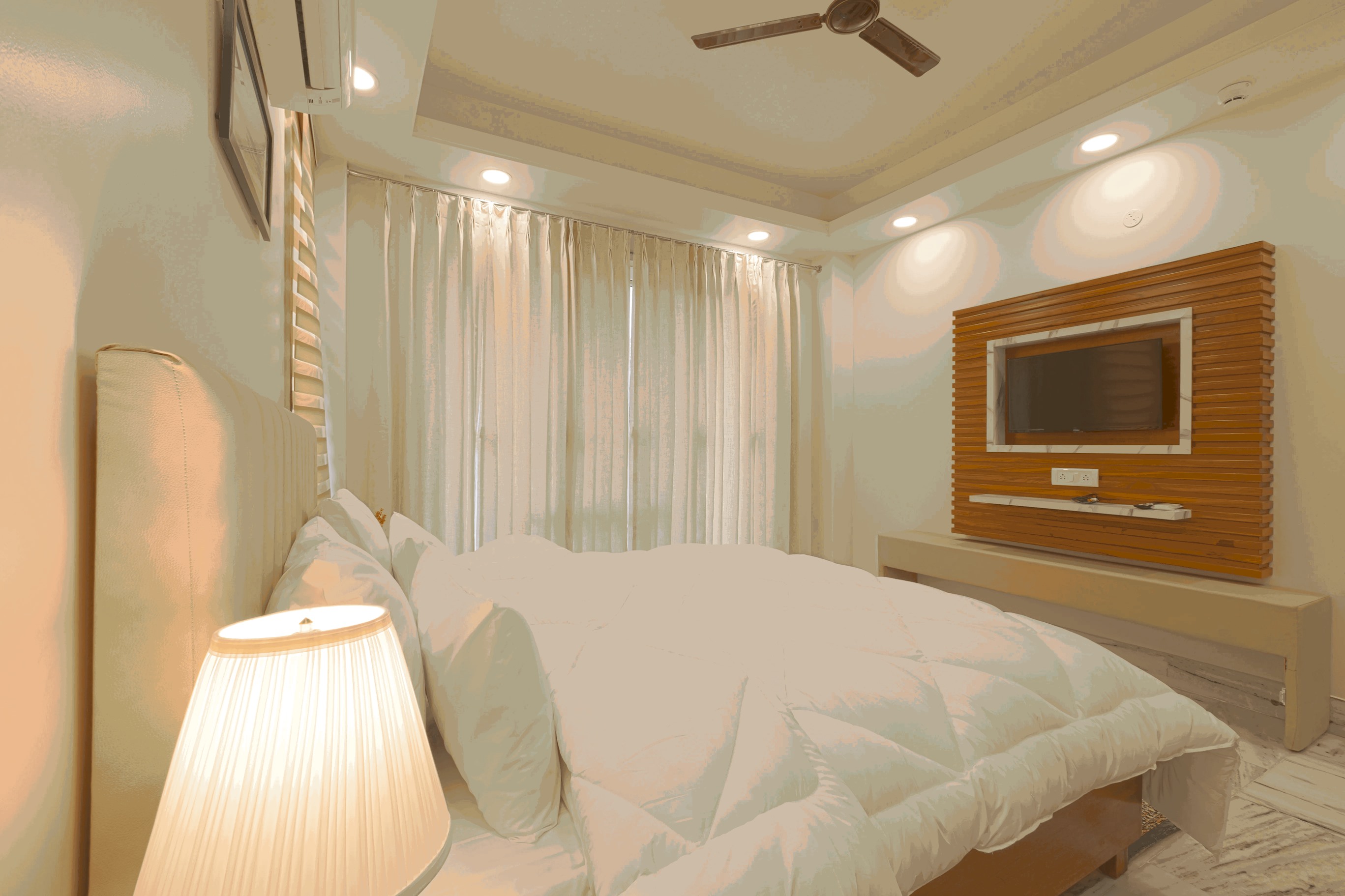"Discover Serenity in This Well-Designed Bedroom: Elegant Decor, Comfortable Furnishings, and a Soothing Color Palette Await at Parfait Street."