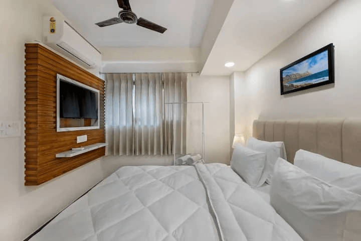 An elegant and well-designed bedroom with tasteful decor, comfortable furnishings, and a soothing color palette, creating a serene and inviting atmosphere.